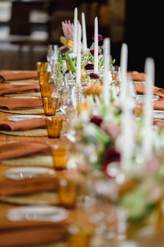 a long table topped with plates and glasses of food at Cloud 9 Luxury Eco Villa in Sedgefield