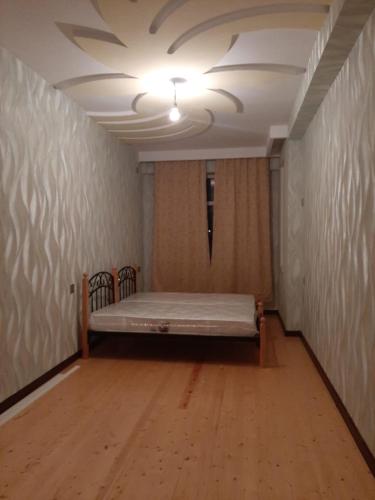 a room with a bed in a room with a ceiling at My sweet home in Qara Qarayev in Baku