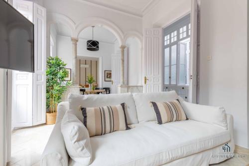 a white couch with pillows in a living room at Living4malaga Stylish Monroy in Málaga