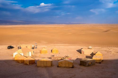 a group of tents in the middle of a desert at Bivouac Dune Iriki in Foum Zguid