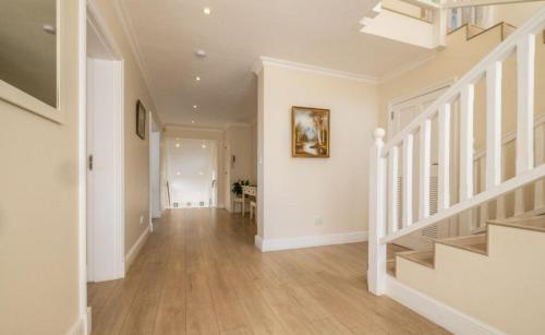 a hallway of a home with white walls and wooden floors at Westhill Luxury Guest House in Knysna