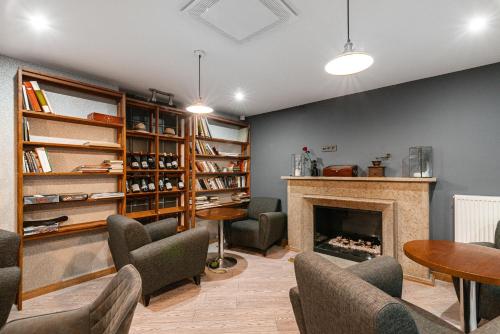a living room with a fireplace and tables and chairs at Rija Fonnental Design Hotel Tallinn in Tallinn