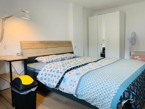 a bedroom with a bed and a trash can at Nice rooms in Beggen house - In Luxembourg city in Luxembourg