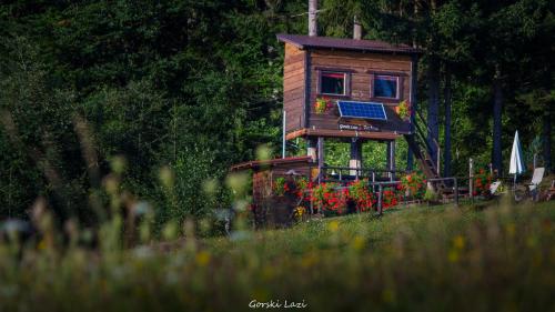 a small tree house with a solar panel on it at Tree House Gorski Lazi in Tršće