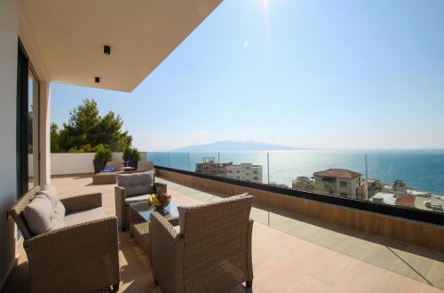 a balcony with a view of the ocean from a house at Meraviglia Boutique Hotel in Sarandë