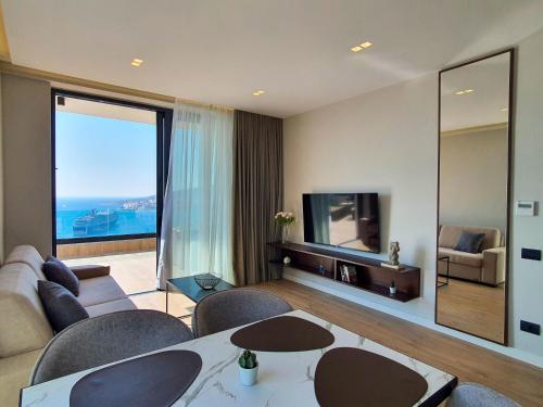 a living room with a couch and a tv at Meraviglia Boutique Hotel in Sarandë