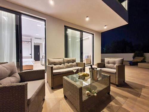 a living room with couches and a table at Meraviglia Boutique Hotel in Sarandë