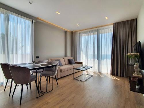 a living room with a couch and a table at Meraviglia Boutique Hotel in Sarandë