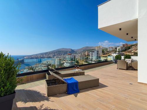 a balcony of a house with a view of the city at Meraviglia Boutique Hotel in Sarandë