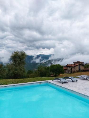 a swimming pool with a view of a mountain at Il Torrione del Trebbia in Bobbio
