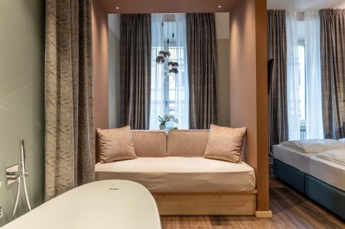 a room with a couch in front of a window at Calepina Alpine Suite in Trento