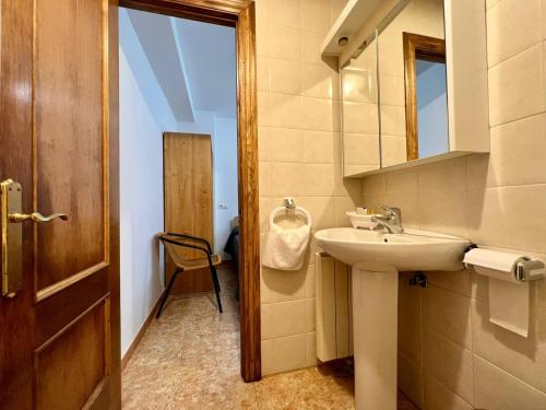 a bathroom with a sink and a mirror at Cozy apartment, FreeWifi, nearby beach in Cadavedo in Cadavedo