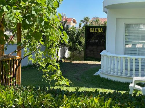 a white house with a sign that reads sauna at Belka Golf Residence Exclusive Apt Poolside in Belek