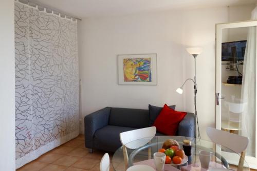 a living room with a couch and a glass table at La Françonne- Gîte Rouge - Drôme Provençale in Mirabel-aux-Baronnies