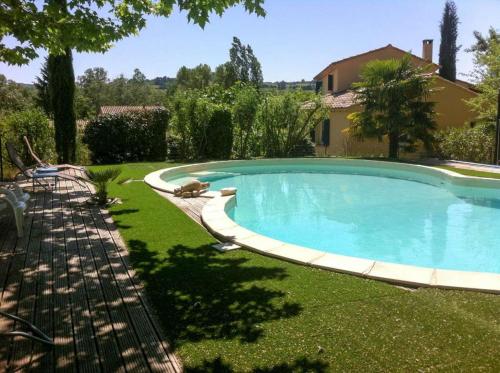 a swimming pool in the yard of a house at La Françonne- Gîte Rouge - Drôme Provençale in Mirabel-aux-Baronnies