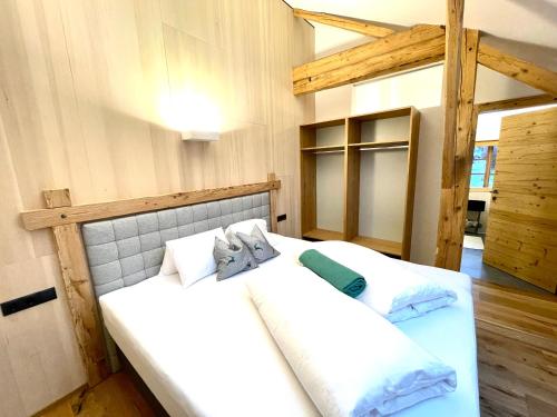 two twin beds in a room with wooden walls at Appartements Zur Post in Gries im Sellrain