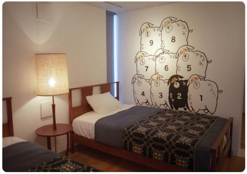 a bedroom with a bed with a cactus wall at The Aoca Tokyo Sanno in Tokyo
