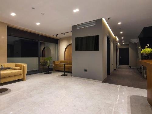 a lobby with couches and a television in a building at Meraviglia Boutique Hotel in Sarandë