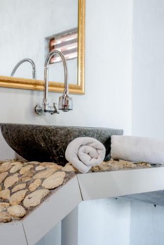 a bathroom with a sink and a mirror at The Granyam Garden Cottage in Nusa Penida