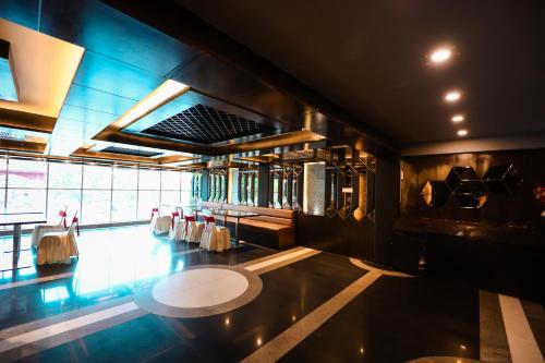 a large room with a table and chairs in it at HOMANSH GALAXY HOTEL in Kānpur