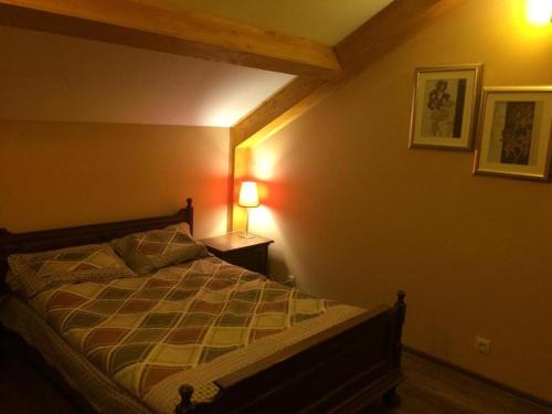 a bedroom with a bed and a lamp on a wall at Two various entire apartments in New Gudauri -Redco, Near Main Gondola in Gudauri