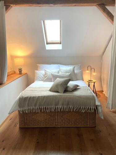 a bedroom with a large bed in a attic at s'Scheunle - dein Ferienhäusle im Donautal in Beuron