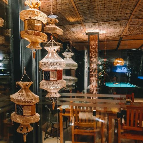 a dining room with a table and some chandeliers at Pousada TeMoana in Ubatuba