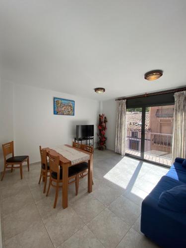 a living room with a table and chairs and a couch at Apartaments Sant Antoni in Ribes de Freser