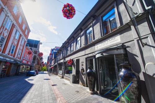 a street with a building with vases on it at The Lamp Hotel & Spa in Norrköping