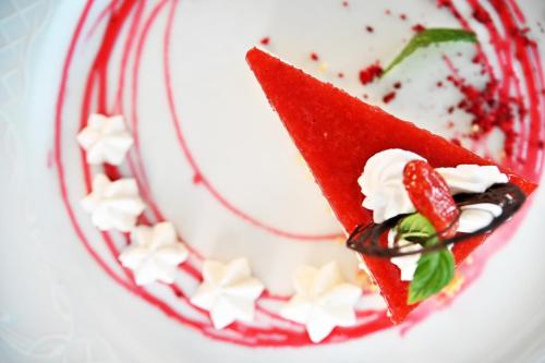 a red velvet dessert with whipped cream and strawberries at Hotel Eger & Park in Eger