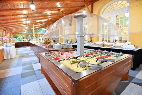 a buffet line with food on display in a restaurant at Hotel Eger & Park in Eger