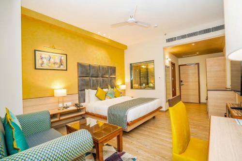 a hotel room with a bed and a living room at The Zenith - A boutique hotel by Hot Millions in Mohali