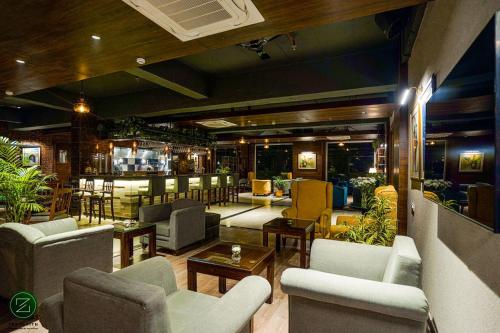 a lobby with couches and chairs and a bar at The Zenith - A boutique hotel by Hot Millions in Mohali