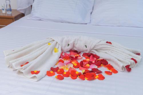 a white blanket with flowers on a bed at Cozy Crib in Malindi