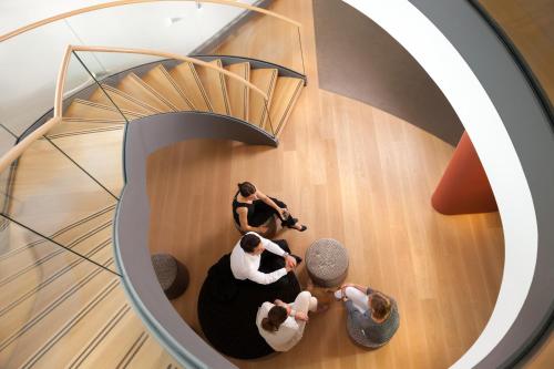 a group of people sitting in a spiral staircase at Dorint Thermenhotel Freiburg in Freiburg im Breisgau