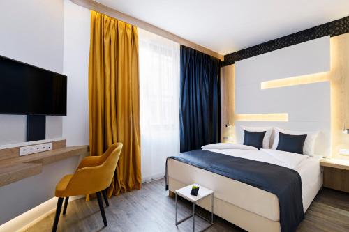 A bed or beds in a room at KViHotel Budapest - the smart hotel