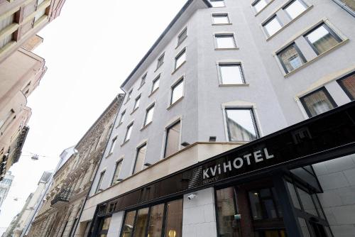 a building with a whittel sign in front of a store at KViHotel Budapest - the smart hotel in Budapest