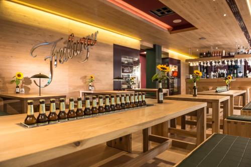 a bar with a bunch of bottles of wine at Dorint Thermenhotel Freiburg in Freiburg im Breisgau