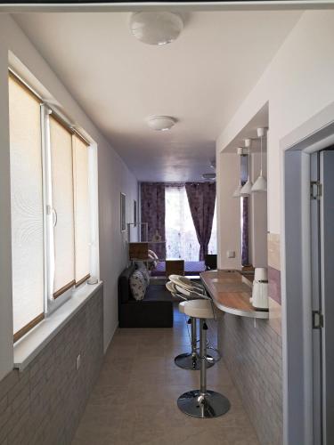 a kitchen with a bar and a living room at Comfortable Ground Floor Studio in Primorsko