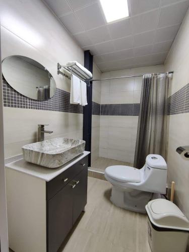 a bathroom with a sink and a toilet and a shower at Kharkhorin hostel in Harhorin