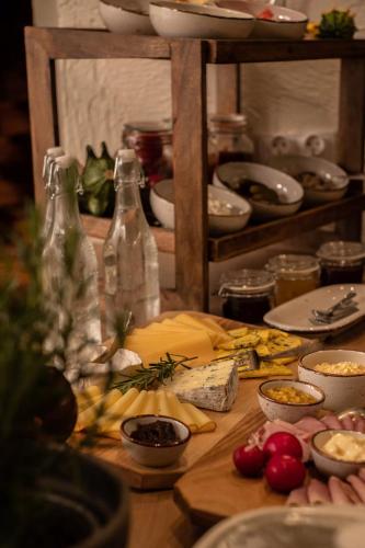 a wooden table with food and bottles on it at Highland Warmia - Gospodarstwo agroturystyczne in Jeziorany