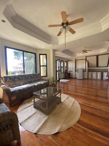 a living room with a couch and a ceiling fan at Tahanan Resort in San Juan