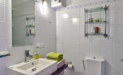a bathroom with a sink and a toilet and a mirror at Villa Lefki in Vamos