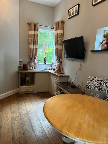 a living room with a table and a window at Stone Lodge B&B in Balrath