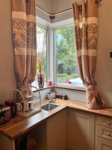 a kitchen with a sink and a window at Stone Lodge B&B in Balrath