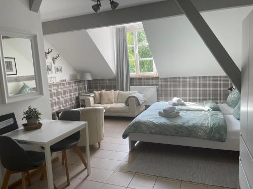 a bedroom with a bed and a living room at Weberhof Apartment 2 in Münster