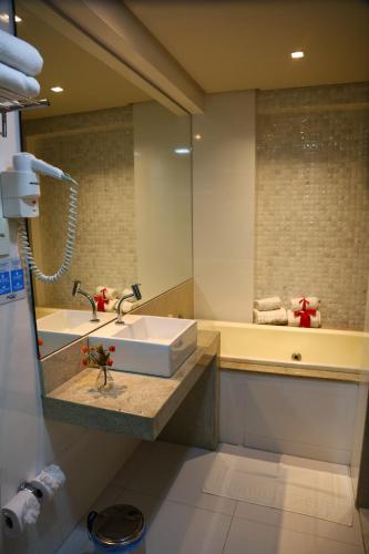 a bathroom with a sink and a mirror at Atmosfera Hotel in Feira de Santana