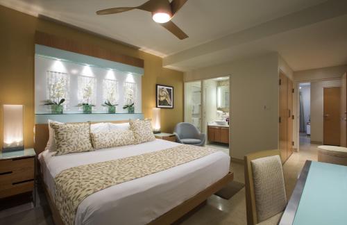 a bedroom with a bed and a desk and a table at Santa Maria Suites Resort in Key West