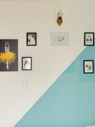 a group of pictures on a wall with stairs at Mi Casa Homestay in Da Lat
