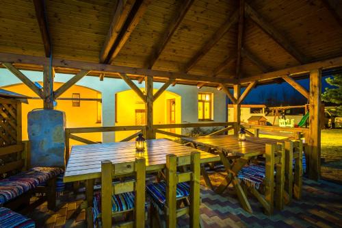 a large wooden table and chairs on a patio at Apartmany Centrum in Pavčina Lehota
